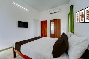 Ένα ή περισσότερα κρεβάτια σε δωμάτιο στο Hotel O Muthalipalayam Bus Stand Coimbatore Formerly Haven Stays