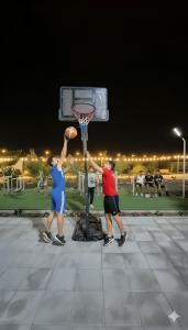 a man and a woman playing a game of basketball at شاليه جوري حتا-4-Chalet Jory Hatta in Būbādī