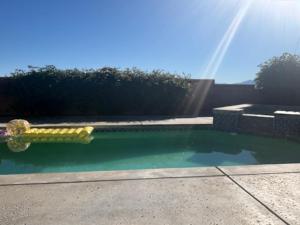 a swimming pool with a yellow object in the water at Desert Vista View in Desert Hot Springs