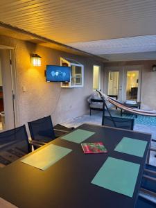 a room with a table and chairs and a television at Desert Vista View in Desert Hot Springs