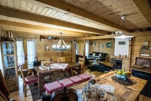 a living room with wooden walls and a dining room at Brvnara Moj san - Log cabin My Dream in Zelin Mrzlovodički