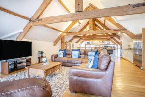 a living room with leather furniture and a flat screen tv at 6 Bed in Blaencwm oc-t32688 in Blaencwm