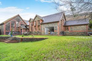 a large brick house with a yard at 6 Bed in Blaencwm oc-t32688 in Blaencwm