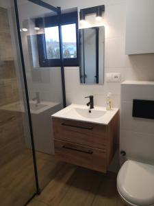 a bathroom with a sink and a toilet and a mirror at Dom z widokiem na góry in Zawodzie +23 photos