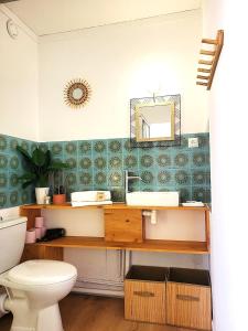 a bathroom with a sink and a toilet at Au Bord De L'eau, Proche plages in Saint-Jean-de-Monts +9 photos