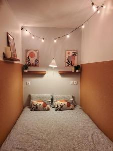 a bedroom with a large bed with lights on it at Au Bord De L'eau, Proche plages in Saint-Jean-de-Monts