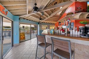 a bar in a restaurant with two chairs at A145 HH Beach & Tennis Resort in Hilton Head Island