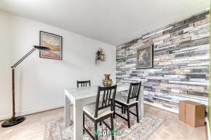 ピエール・ベニットにあるREPUBLIQUE - LYON 2 - KP - Lumineux et chaleureux T3 aux portes de Lyonのレンガの壁のダイニングルーム(テーブル、椅子付) +4枚の写真