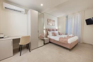 a hotel room with a bed and a desk at B&B IL MORO Boutique Rooms in Siena