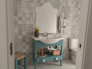 a bathroom with a blue sink and a mirror at La casa de loto in Alcalá de los Gazules +36 photos