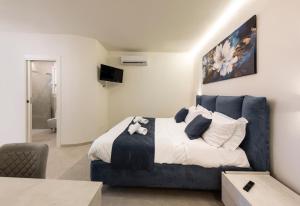 a bedroom with a bed with a blue couch at B&B IL MORO Boutique Rooms in Siena