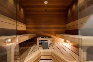 a sauna with wooden walls and wooden flooring at Le Chalet Lingonberry D14 Ski-in Ski-out by Aavalevi in Levi