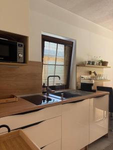 a kitchen with a sink and a window at Chata Spomienka in Lúčky +2 photos