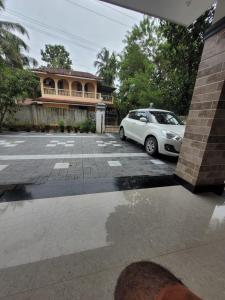 a car parked in a parking lot in front of a house at Liyano homestay in Palakkad