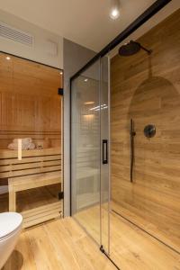 a bathroom with a shower and a toilet and a tub at REST4U APARTAMENTY z SAUNAMI in Szczyrk +34 photos