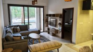 a living room with a couch and a tv at Al-Raha Luxury apartment in Aqaba