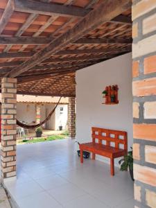 a wooden bench in a room with a brick wall at Aguapé 4 in Barreirinhas