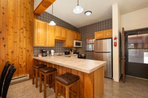 a kitchen with wooden cabinets and a counter top at Beaver Village Unit #0834 in Winter Park