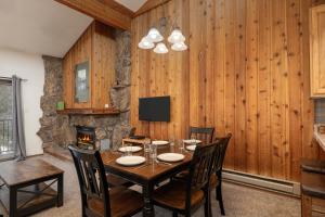 a dining room with a table and a fireplace at Beaver Village Unit #0834 in Winter Park