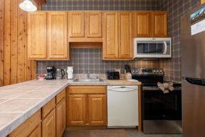 a kitchen with wooden cabinets and a counter top at Beaver Village Unit #0834 in Winter Park +28 photos