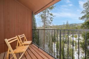 a wooden chair sitting on a deck with a view at Beaver Village Unit #0834 in Winter Park
