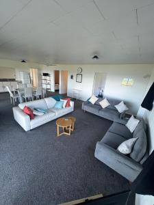 a large living room with couches and a table at Coopers Haven- Beachfront House in Coopers Beach