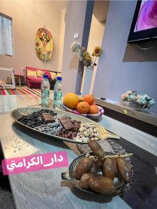 a table with two trays of food on it at DAR Karamti in Tozeur +6 photos