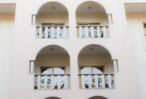 a white building with two balconies on it at Hotel Rainha D. Amélia, Arts & Leisure in Castelo Branco