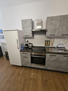 a kitchen with a sink and a stove top oven at A due passi dal centro in Castelfidardo