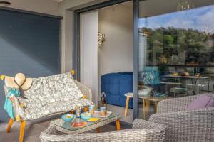 a living room with a couch and a table at Casa Pouty Beach in Bastia
