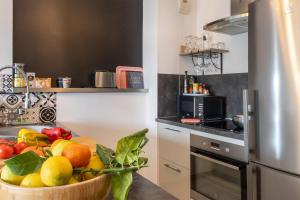 a kitchen with a bowl of fruit on a table at Casa Pouty Beach in Bastia