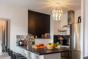 a kitchen with a counter with a bowl of fruit at Casa Pouty Beach in Bastia