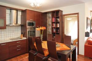 a kitchen with a table and chairs and a room at Central Grevena Retreat with Mountain Views in Grevena