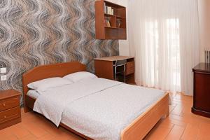 a bedroom with a large bed and a wall at Central Grevena Retreat with Mountain Views in Grevena