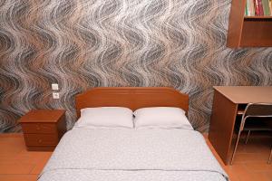 a bedroom with a bed and a wall at Central Grevena Retreat with Mountain Views in Grevena +17 photos