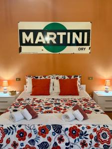 a bedroom with a bed with a marlin sign on the wall at BACCANO Guest House in Montepulciano