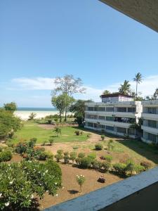 a view of the beach from the balcony of a building at Kibaki Ocean Front Residence 18 in Mombasa