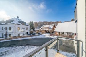 a view from the balcony of a house with a swimming pool at Aspen Lodge Apartments & Sauna in Černý Dŭl
