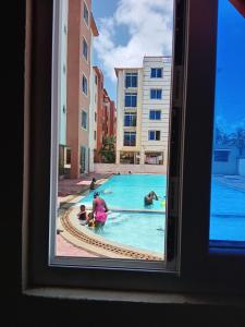 a woman and two children playing in a swimming pool at Mtwapa Luxurious Residence with Pool B1M in Mombasa