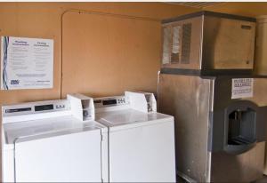 a kitchen with two washes and a microwave at Sweet Dream Inn in Pensacola