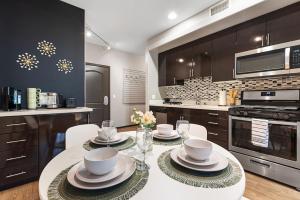 a kitchen with a table with plates and bowls on it at Irvine Luxury Living | Pool, Gym & Prime Location in Irvine