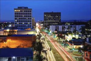 a city at night with buildings and street lights at Modern Room Nested In The Heart Of Orange County in Tustin