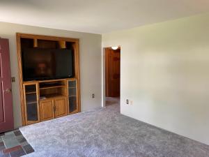 an empty living room with a flat screen tv at 2 bedroom home in a quiet neighborhood in Plattsburgh