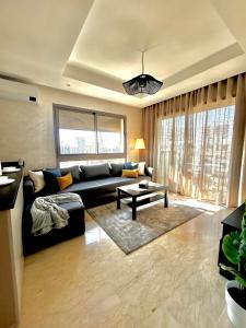 a living room with a couch and a table at Luxury Studio in a secured residence in Aïn Harrouda +18 photos