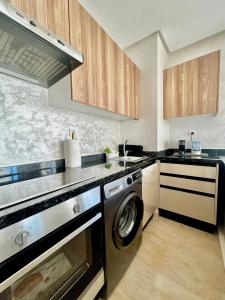 a kitchen with a washer and dryer in it at Luxury Studio in a secured residence in Aïn Harrouda