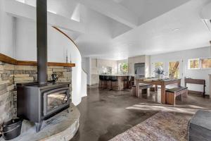 a living room with a fireplace and a dining room at Montgomery Ranch - Main House in Redding