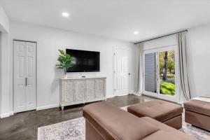 a living room with a couch and a flat screen tv at Montgomery Ranch - Main House in Redding