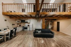 a living room with a black couch and a table at Palatul Agoston Galgon in Timişoara +17 photos