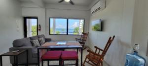 a living room with a couch and a table and chairs at Lickety Split 2 - Northside, Oceanview Retreat in Caye Caulker +11 photos