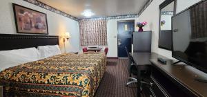 Turnpike Motel Richmond VA by Hotel O US 60 في ريتشموند: غرفة فندقية مع سرير وتلفزيون بشاشة مسطحة